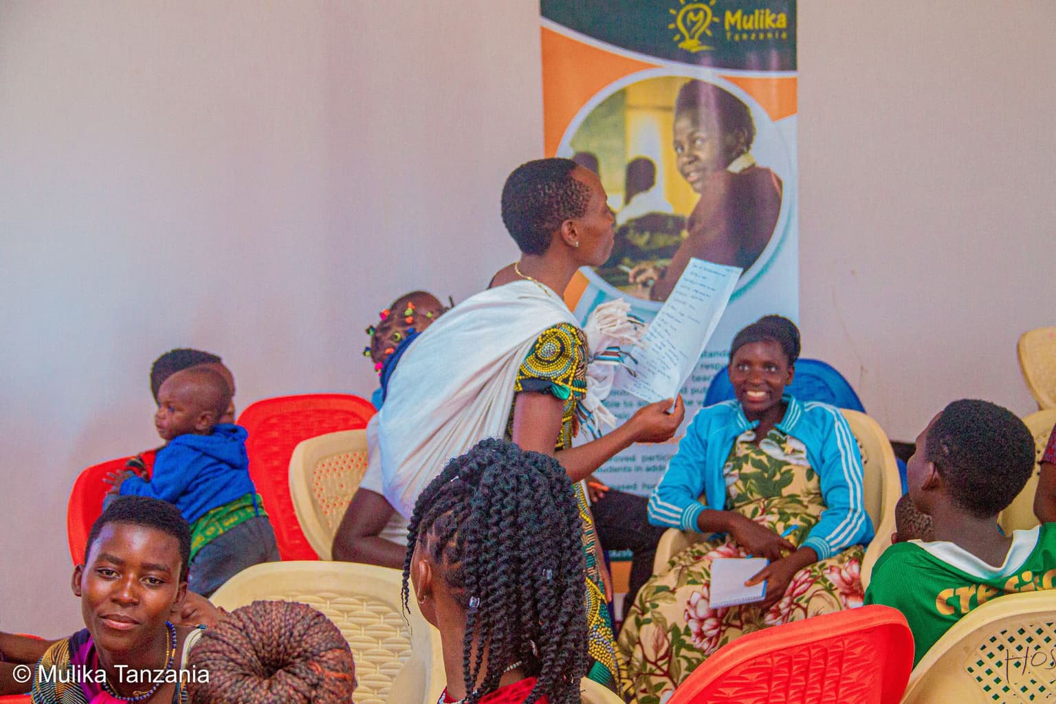 A mentor guiding members through programme materials
