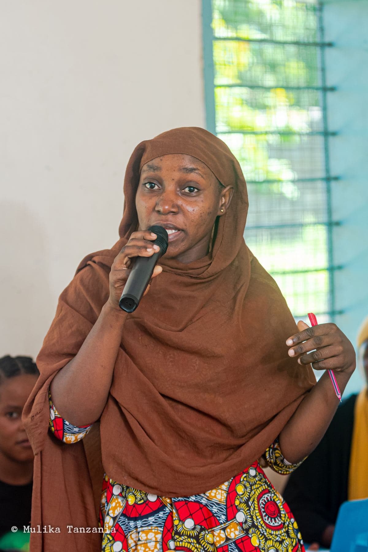 Young woman addressing her group during a YEE session